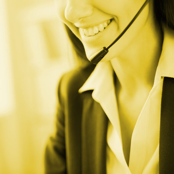 Toothy smile of young businesswoman with headset
